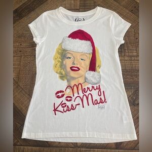 Marilyn Monroe in a Santa hat with the festive phrase "Merry Kiss-Mas!"